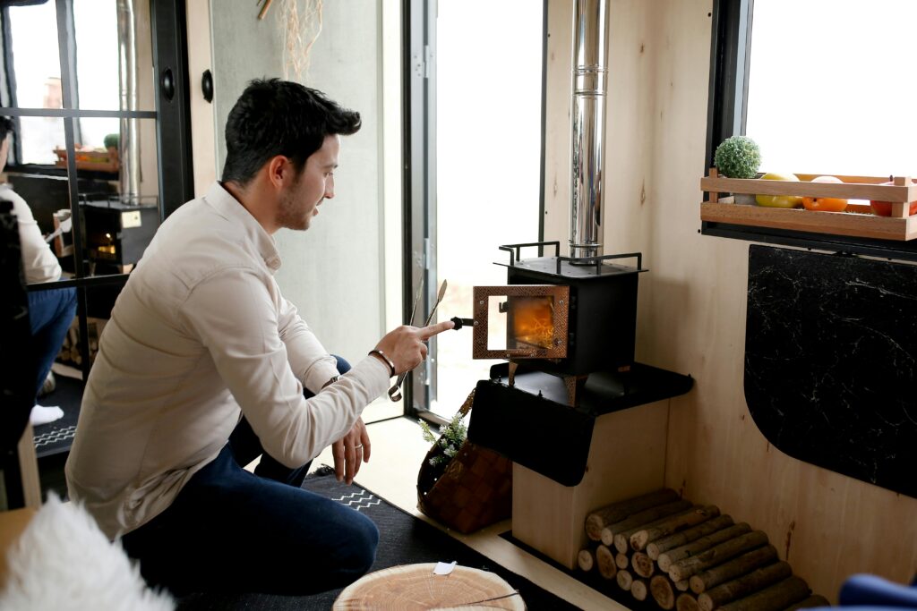 DIY Small Wood Stove Installation in Off-Grid Cabin Step-by-step visual of a safe wood stove installation in a small log cabin, featuring vent pipe setup, clearances, and hearth protection.